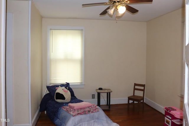 bedroom with ceiling fan and dark hardwood / wood-style flooring