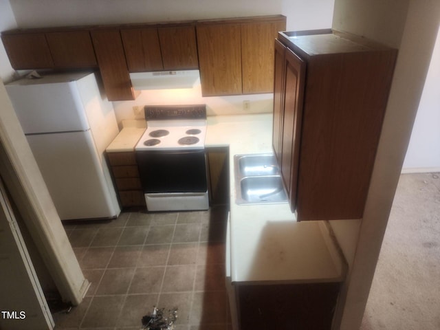 kitchen featuring range with electric cooktop, sink, and white fridge