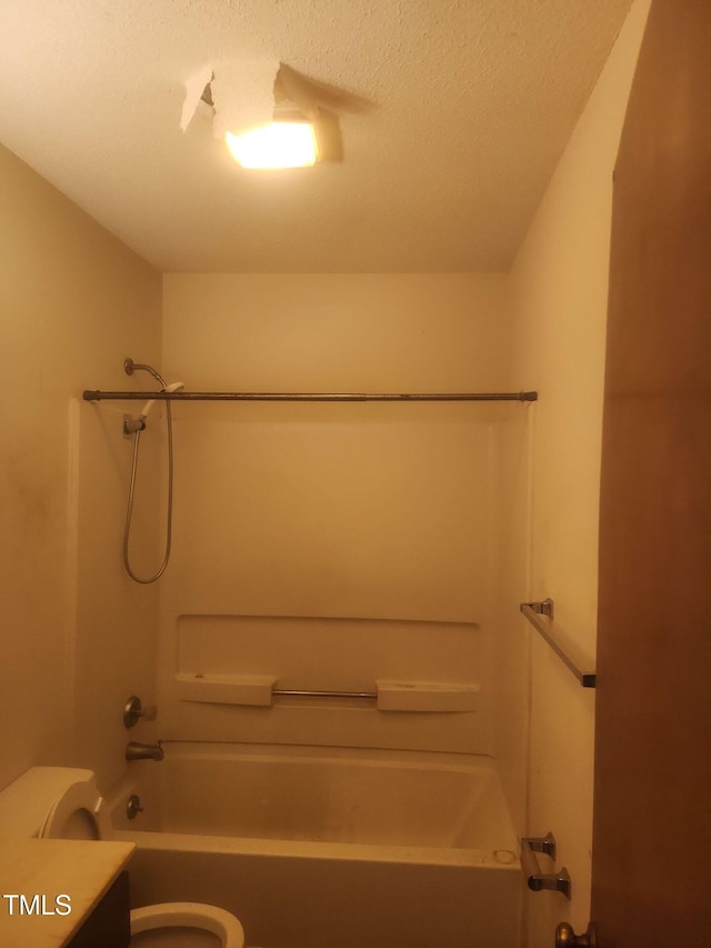 full bathroom featuring vanity, a textured ceiling, toilet, and shower / bath combination