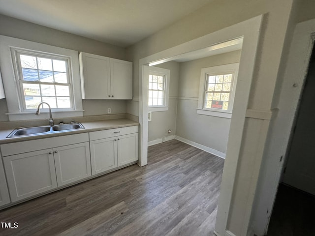 kitchen with white cabinets, plenty of natural light, and sink