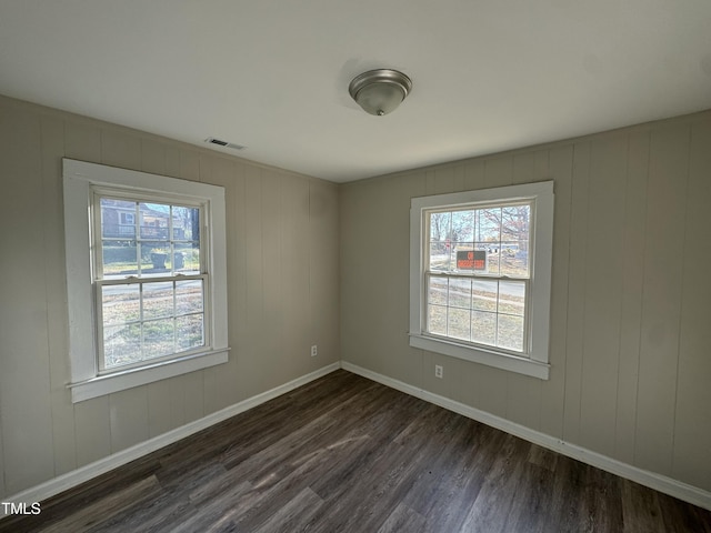 spare room with dark wood-type flooring