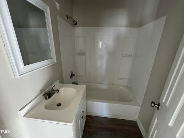 bathroom featuring hardwood / wood-style flooring, vanity, and shower / bathtub combination