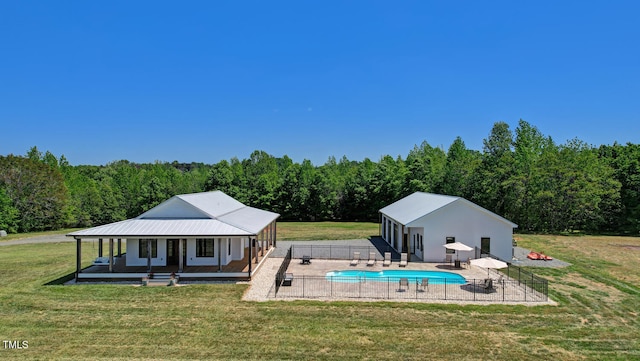 back of house featuring a lawn and a patio