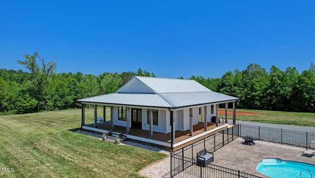 back of house with a lawn, a patio, and a fenced in pool