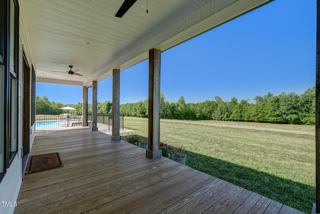 deck with a yard and ceiling fan