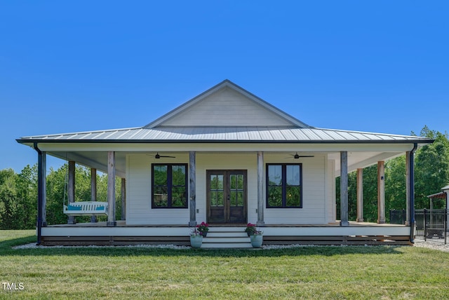 back of property featuring ceiling fan, a porch, a yard, and french doors