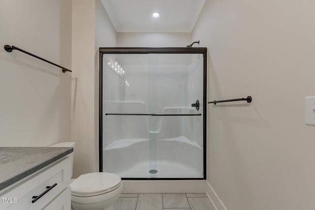 bathroom featuring ornamental molding, vanity, a shower with door, tile patterned flooring, and toilet