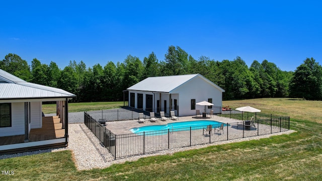 view of pool with a patio area and a lawn