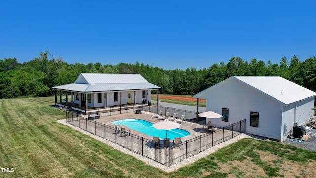 view of swimming pool with a patio area and a yard