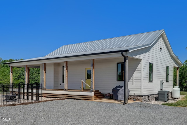 view of front of property with a porch and cooling unit