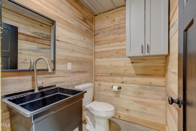 bathroom featuring vanity, toilet, wood ceiling, and wooden walls