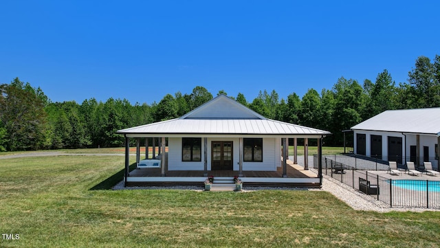 view of front facade featuring an outbuilding, a patio, and a front lawn