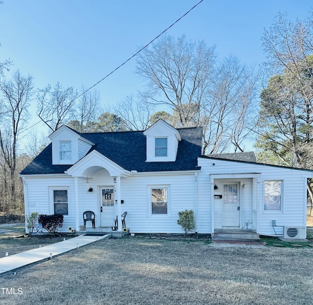 view of front of house featuring a front lawn and ac unit