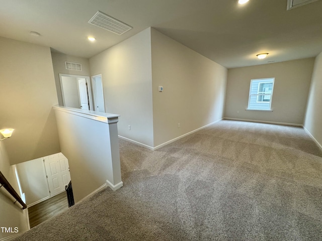 unfurnished room with light carpet