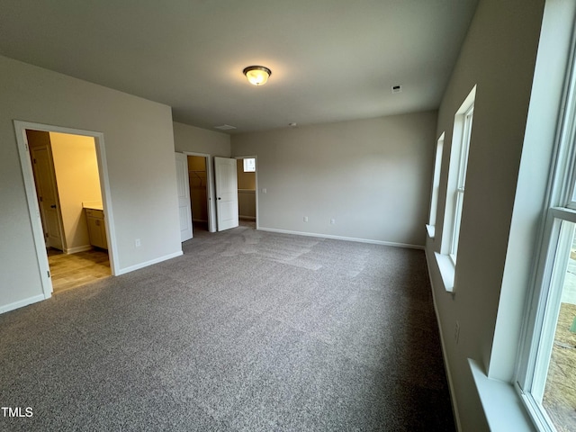 unfurnished bedroom with carpet and ensuite bathroom