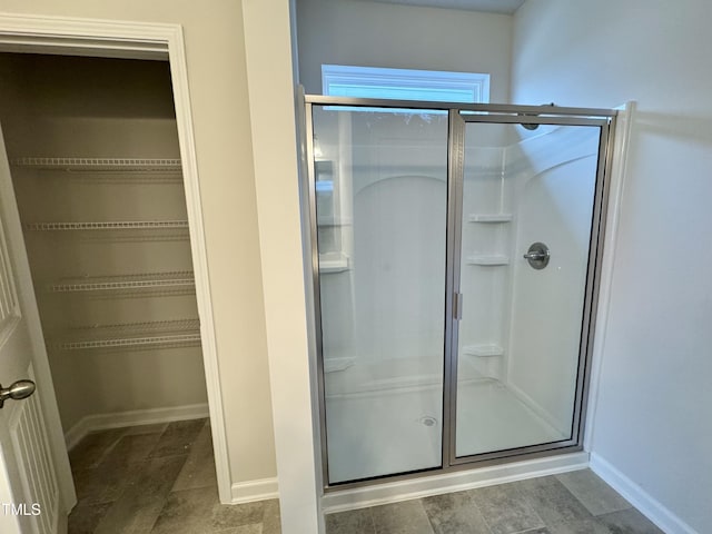 bathroom with a shower with door