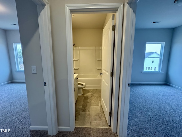 bathroom featuring vanity, a healthy amount of sunlight, and toilet