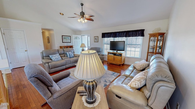 living room featuring hardwood / wood-style floors, ceiling fan, and lofted ceiling