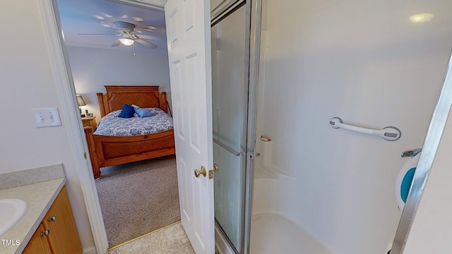 bathroom with vanity, a shower with door, and ceiling fan