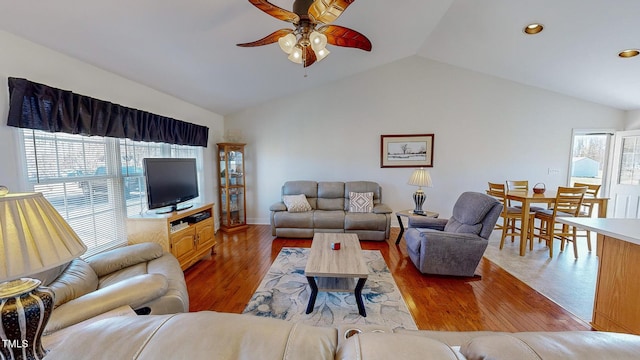 living room featuring ceiling fan, a healthy amount of sunlight, vaulted ceiling, and hardwood / wood-style flooring