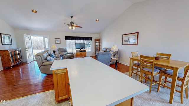 interior space with ceiling fan, lofted ceiling, and light hardwood / wood-style flooring