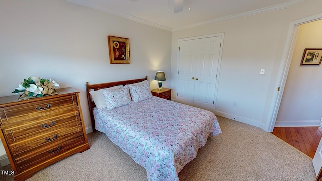 bedroom featuring hardwood / wood-style floors, ornamental molding, and a closet