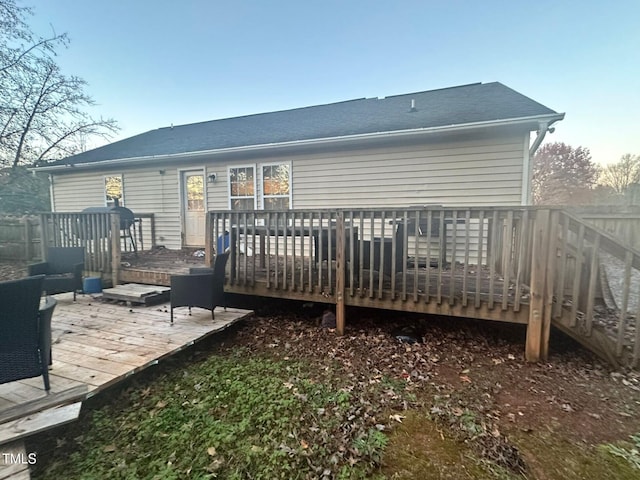 rear view of house featuring a wooden deck