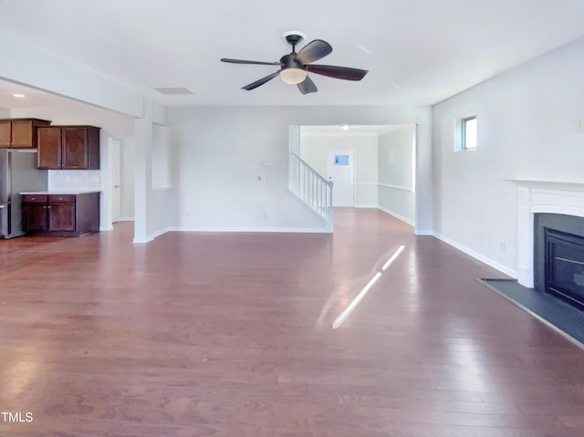 unfurnished living room featuring hardwood / wood-style flooring and ceiling fan