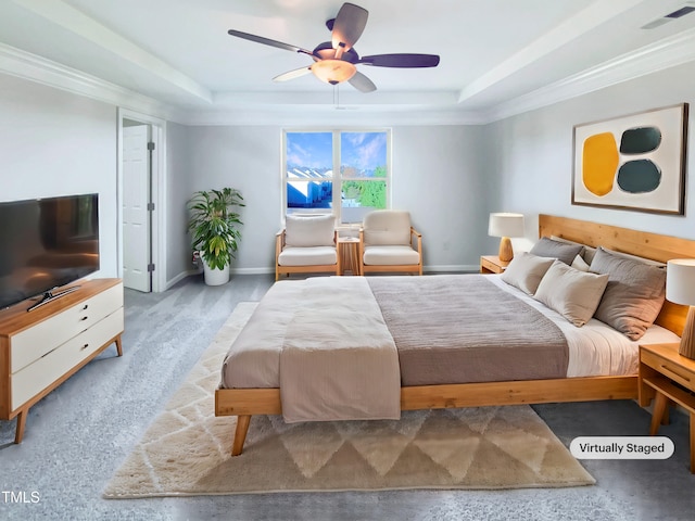 bedroom with a raised ceiling, ceiling fan, and ornamental molding