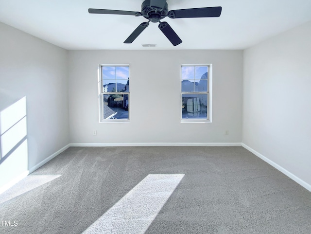 spare room with carpet flooring and ceiling fan