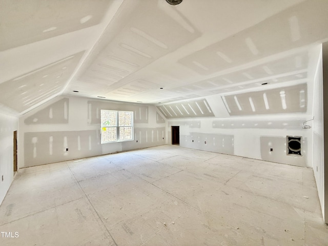 additional living space featuring vaulted ceiling