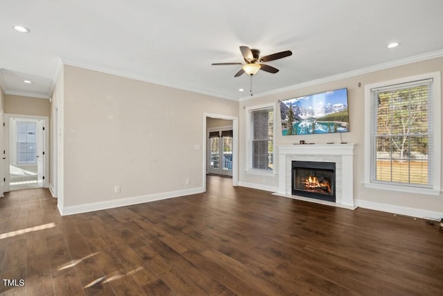 unfurnished living room featuring dark hardwood / wood-style flooring, ceiling fan, and ornamental molding