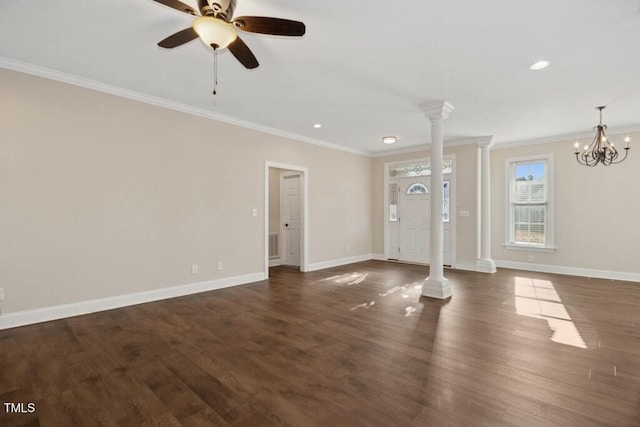 unfurnished living room featuring ornate columns, crown molding, dark wood-type flooring, and ceiling fan with notable chandelier