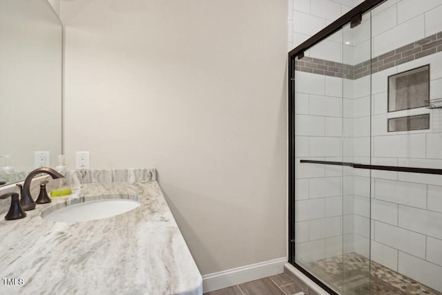 bathroom featuring vanity and a shower with shower door