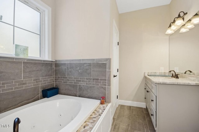 bathroom with tile patterned floors, vanity, a healthy amount of sunlight, and tiled bath