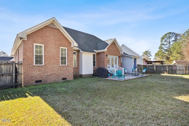 rear view of house featuring a yard and a patio