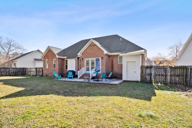 rear view of property with a patio and a lawn