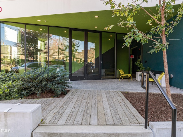 view of exterior entry featuring a wooden deck