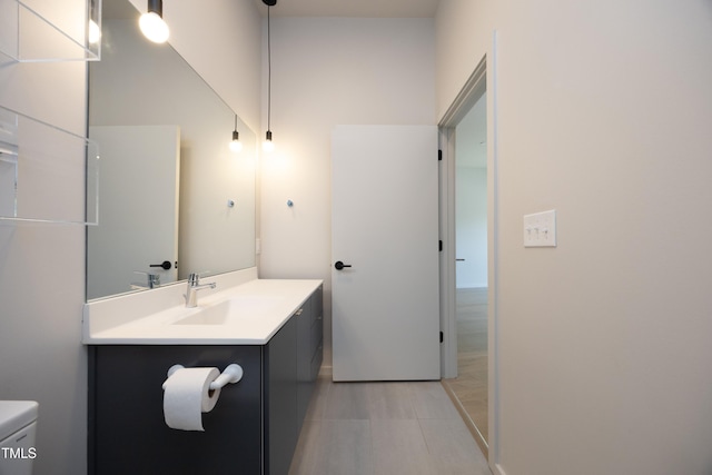 bathroom featuring tile patterned floors, vanity, and toilet