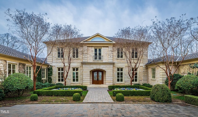 view of front of house with stone siding and french doors