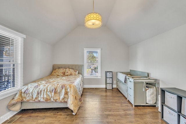 bedroom with hardwood / wood-style flooring and vaulted ceiling