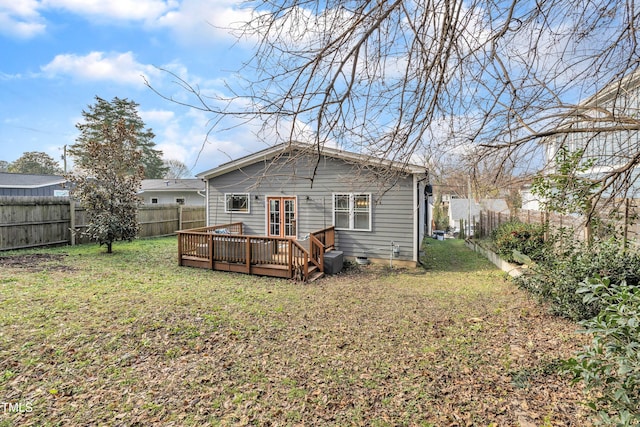 rear view of house with a yard and a deck