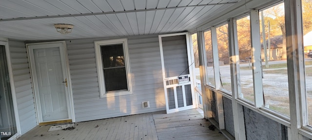 unfurnished sunroom with wooden ceiling