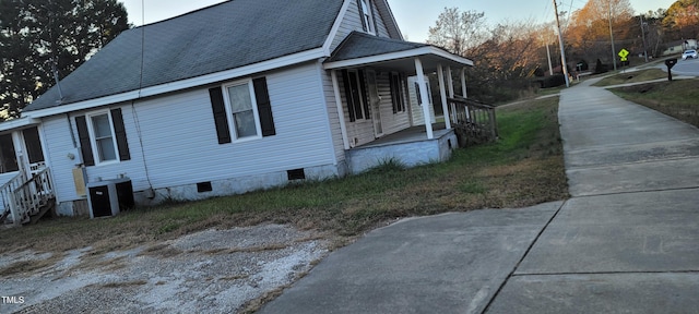 view of side of home with covered porch