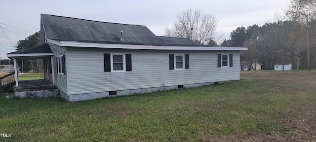 view of side of home with a yard