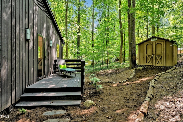 view of yard featuring a storage shed and a deck