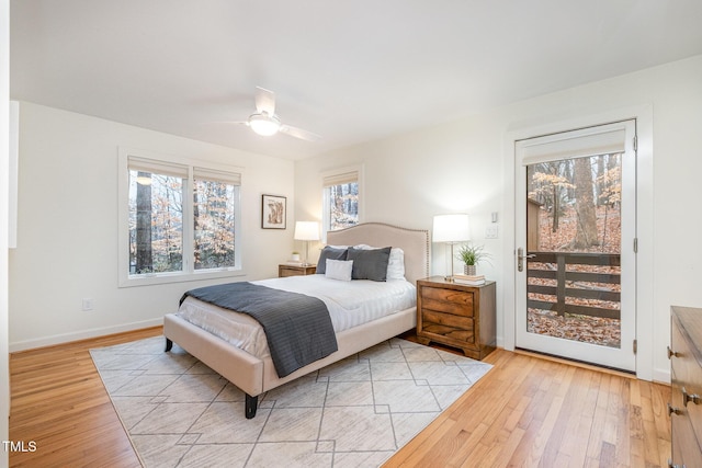 bedroom with access to exterior, light hardwood / wood-style flooring, and ceiling fan