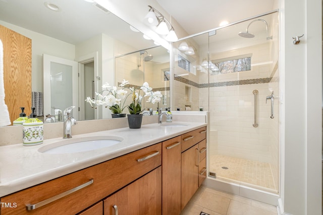 bathroom with tile patterned floors, vanity, and a shower with shower door