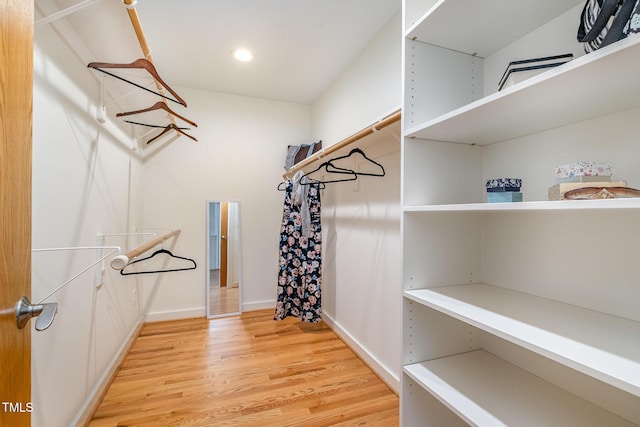 spacious closet featuring light hardwood / wood-style floors