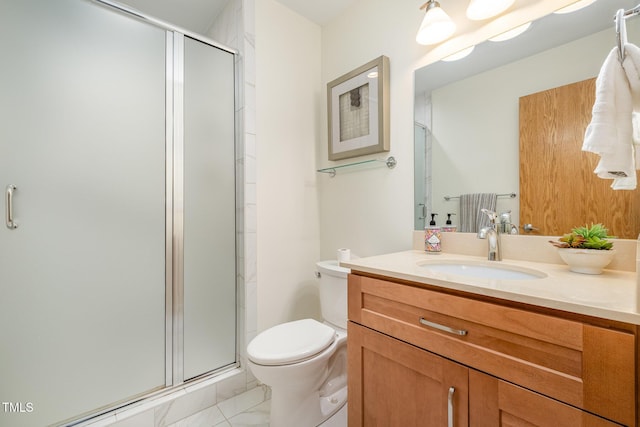 bathroom with a shower with door, vanity, and toilet